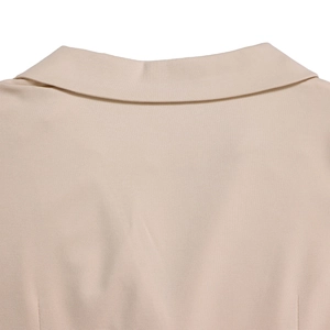 Close-up of beige twill fabric texture and collar stitching on elegant ladies top