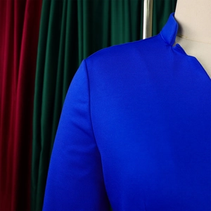 Detail of royal blue stand-up collar top showing fine horizontal knit fabric texture