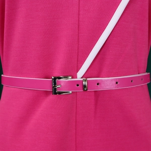 Detail of rose pink dress with white trim accents and a thin matching belt with silver buckle
