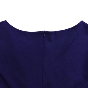 Close-up of the concealed zipper on a navy blue dress with textured woven fabric