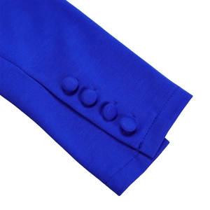 Close-up of elegant blue ruffle top sleeve with four matching fabric-covered buttons