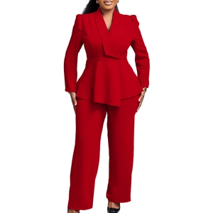 Detail of red two-piece peplum blazer suit with matching high-waisted wide leg trousers