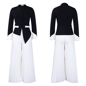 Detail view of contrast blazer top and pleated wide-leg trousers in black and white