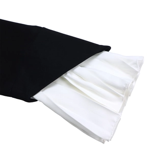 Detail of elegant black sleeve with white pleated bell cuffs showing contrast texture