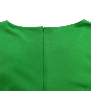 Close-up of invisible zipper and stitching on a solid green pencil dress neckline