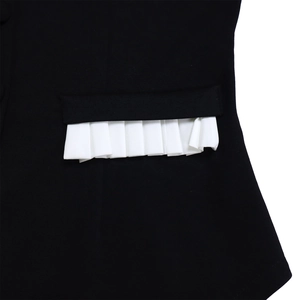 Detailed view of black pocket with white pleated trim and high-quality woven fabric texture