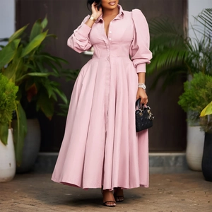 Detail of pink long-sleeved button-down dress with elegant pleated flared skirt