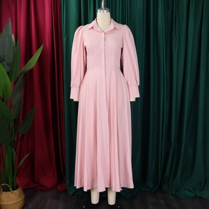 Detail of pink long-sleeved shirt dress featuring puff sleeves and an A-line skirt silhouette