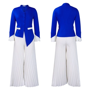 Detail of royal blue blazer with pleated flare sleeves and white wide-leg trousers