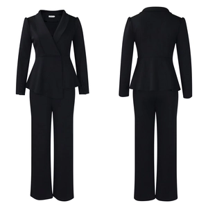 Detail of elegant black blazer featuring a peplum waist ruffle and matching trousers