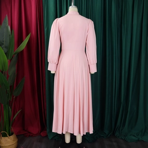 Detail view of pink long-sleeved maxi dress with high waist and wide hem design from back