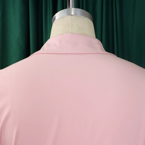 Detail of pink long-sleeved dress showing the elegant collar and smooth fabric texture