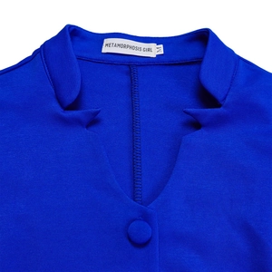Detail of royal blue blazer collar with brand label and matching fabric button