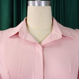 Detail of pink shirt collar and fabric texture on a mannequin with classic lapel design