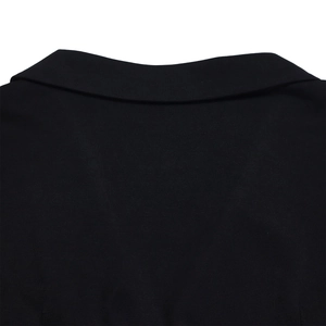Close-up of black notched lapel neck detail on elegent long sleeve office suit top
