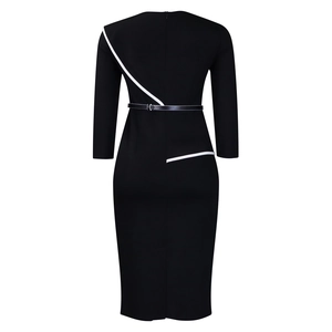Rear view of a slim black dress with white contrast piping and silver buckle belt details