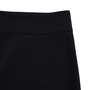 Detailed macro view of the elastic waistband and stitching on black wide-leg trousers
