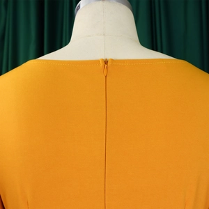Detail showing the seamless back invisible zipper on the ginger yellow flared dress