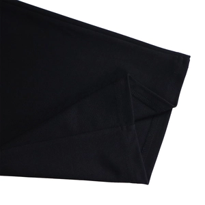Close-up of double-stitched hem and high-density knitted texture on black fabric