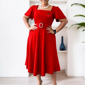 Detail of red square neck dress featuring 3D floral accent and sparkling rhinestone buckle