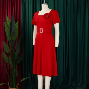Detail of red square neck dress featuring ruffled sleeves and 3D floral brooch ornament