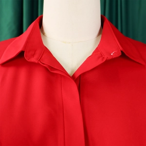 Detail of red shirt collar with smooth texture and sleek lapel on a white mannequin