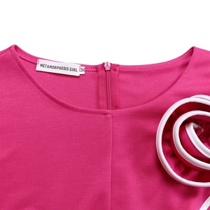Detail of rose red dress featuring round neck, back zipper and 3D floral ruffles