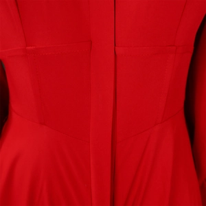 Detailed close-up of the waist seam and precision stitching on this red long-sleeve dress