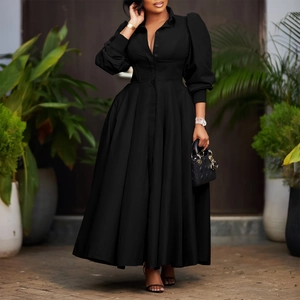 Detail of elegant black long-sleeve dress featuring button-down collar and waist cinching