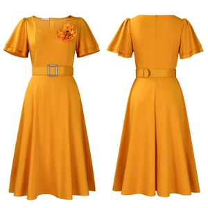 Detail of square neck yellow dress with ruffle sleeves, rhinestone belt, and floral brooch