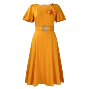 Detailed view of yellow square neck dress with tiered ruffle sleeves and fabric flower