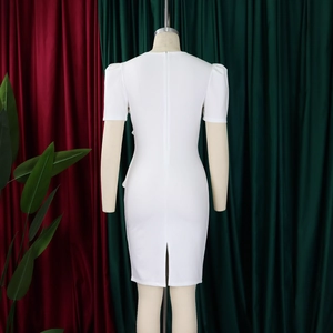 Detail of the white fitted dress back with invisible zipper and elegant slit hemline