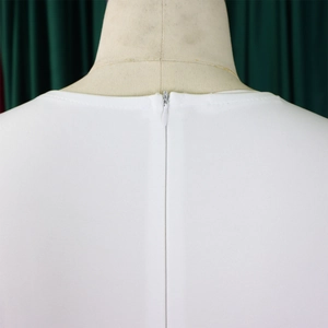 Detail shot of invisible back zipper on a solid white ruffle short sleeve dress