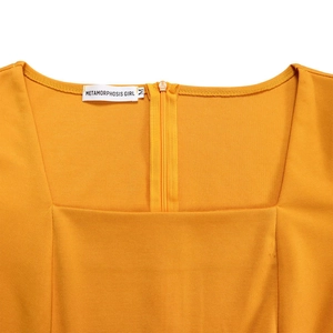 Detail of square neckline and back zipper on bright yellow high waist dress