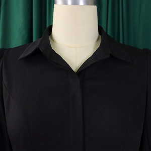 Detailed view of the crisp lapel collar and smooth woven fabric on this black elegant dress