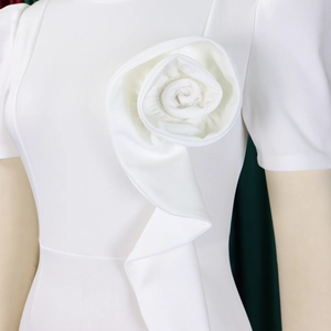 Detail of the 3D handmade rose and elegant ruffles on the white short sleeve dress