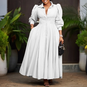 Detail of white long sleeve shirt dress with puff sleeves and cinched waist design