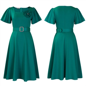 Detail of square neckline with fabric flower and rhinestone buckle on dark green dress