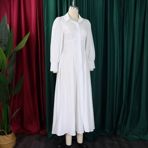 Detail of elegant white shirt dress showing puff sleeves and classic lapel collar