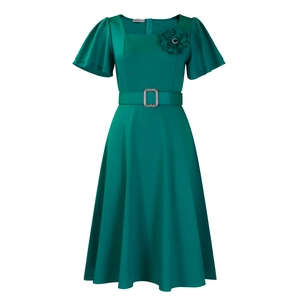 Close-up of square neck, ruffled sleeves, and 3D floral accent on dark green dress