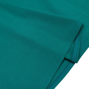 Detailed close-up of teal knit fabric with high-quality double-needle flat sewing stitches