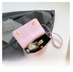 Detail of pink crossbody bag interior with large capacity and gold magnetic closure