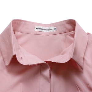 Detailed close-up of a pink shirt collar with neat stitching and sizing label