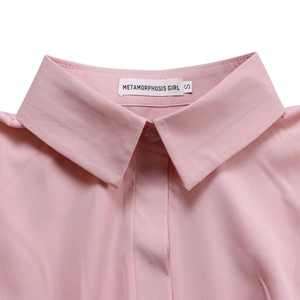 Close-up of pink long-sleeved shirt collar with classic lapel and brand label detail