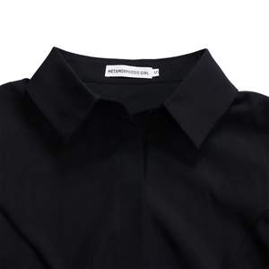 Detail of the elegant black pointed shirt collar with brand label and size S tag