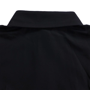 Detail of the classic pointed collar on a solid black long-sleeve elegant shirt dress