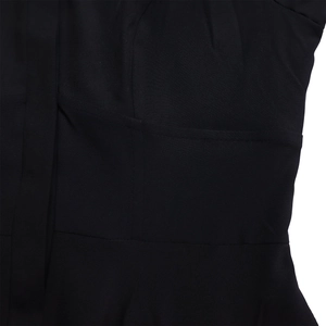 Close-up of the black fabric texture and fine stitching detail of the midi shirt dress