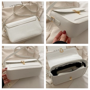 Détails du sac à main en cuir blanc avec fermoir doré et texture grainée fine