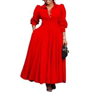 Detail of elegant red long sleeve dress with corset waist and pleated maxi skirt