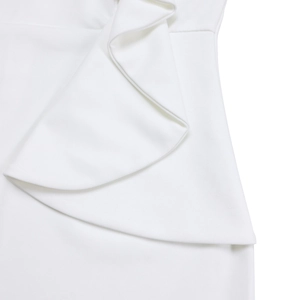 Close-up of elegant white ruffled waist detail and knit texture on this stylish dress